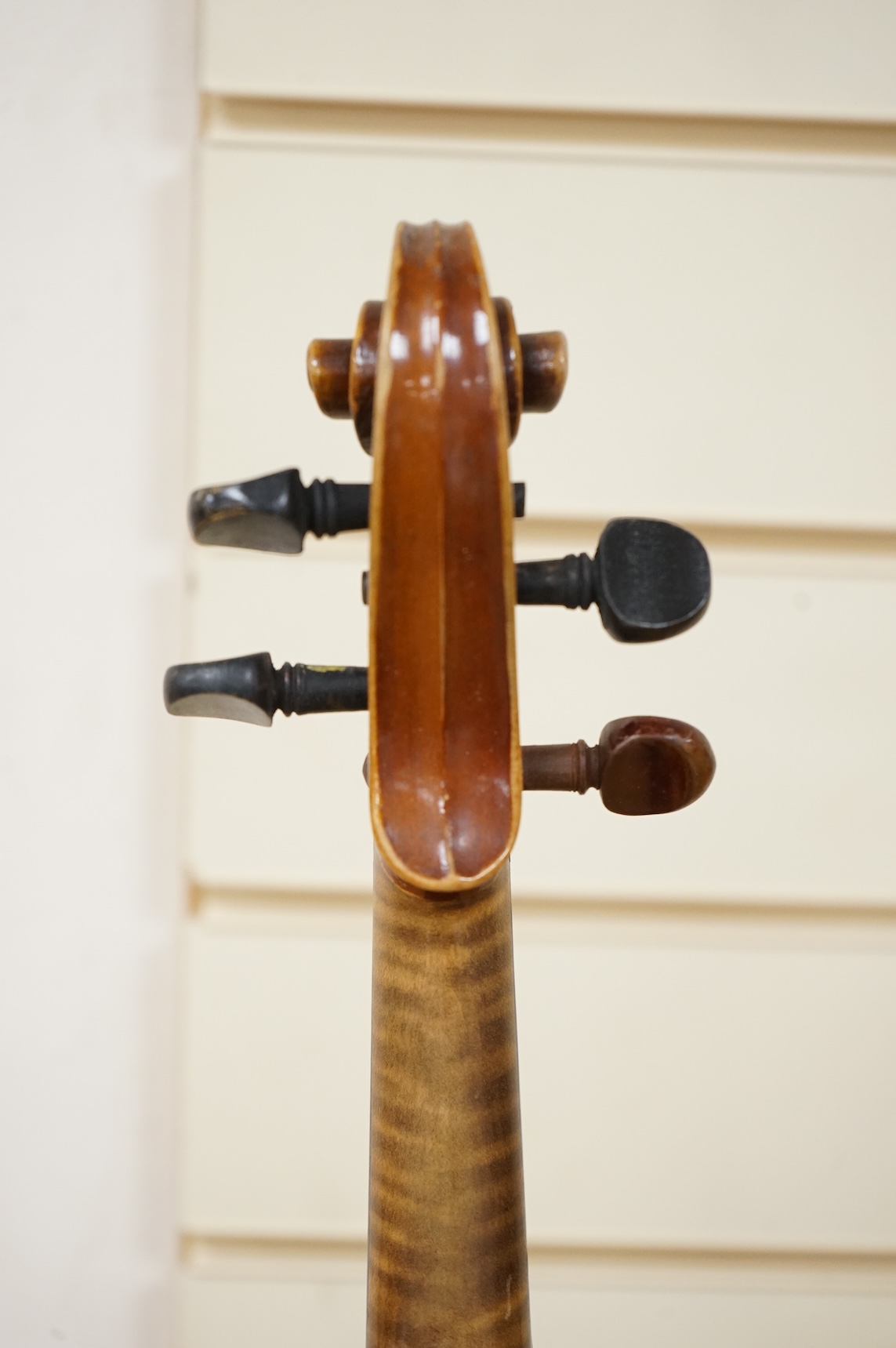 Five cased 20th century violins, including; a German violin, two Czech violins, a three-quarter size violin with a label for Bienfait, and a Romanian quarter size violin, all in cases or the remains of cases.